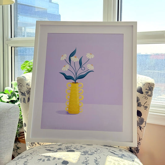 "Daisy Whimsy" whimsical daisy art print with pastel floral wall art. dreamy soft print in a frame sitting on a chair