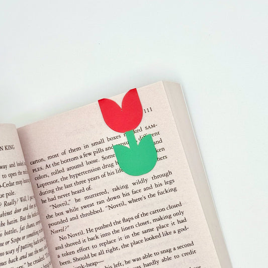 Red tulip magnetic flower bookmark folded over book page