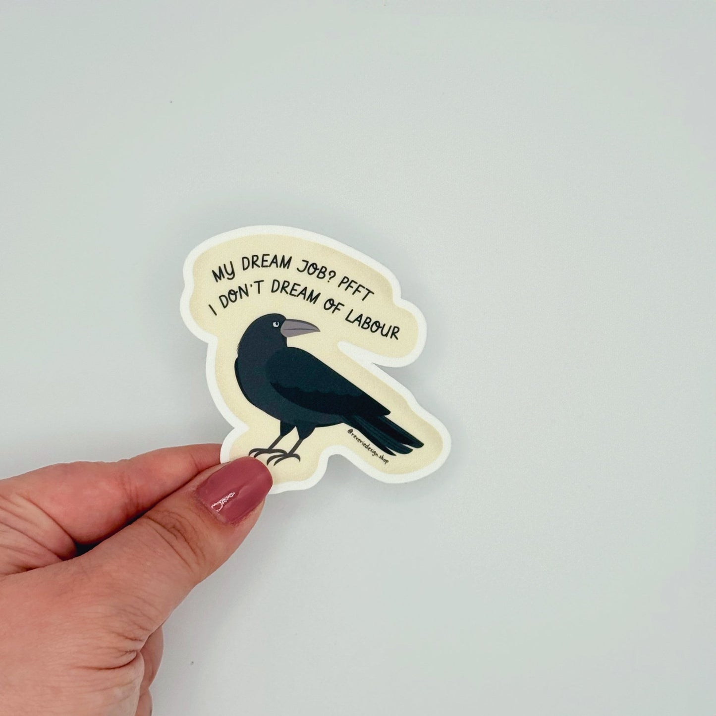Matte sticker featuring smug angry crow and anti-work sentiment with text ‘My dream job? Pfft. I don’t dream of labor’