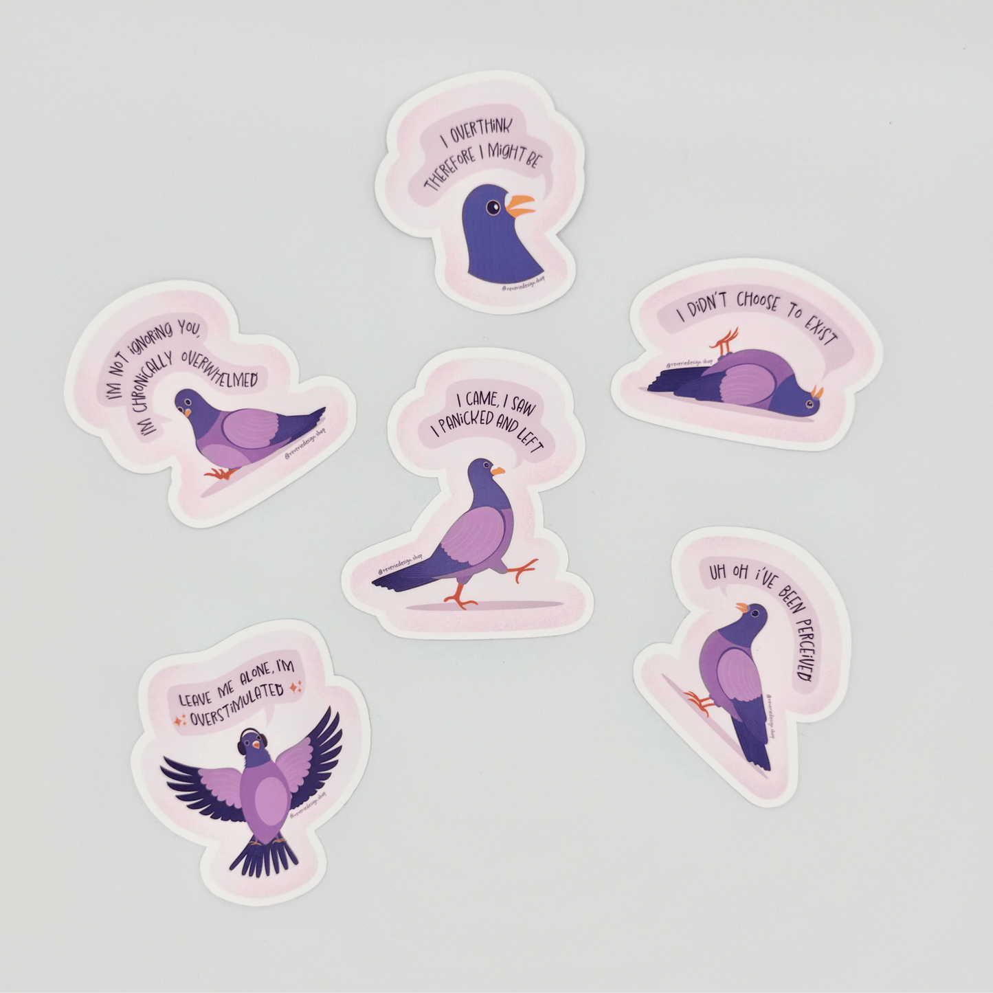 Top shot of full set of Pigeon Panic Party stickers scattered. Funny neurodivergent pigeons