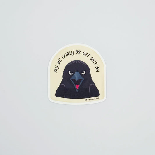 Angry crow sticker with text ‘Pay me fairly or get shit on'