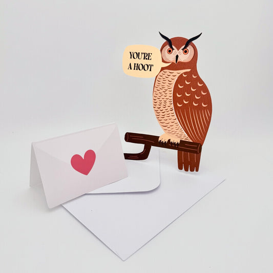 Die-cut greeting card shaped like a great horned owl with text ‘You’re a Hoot' and a folded card that is removable and blank inside