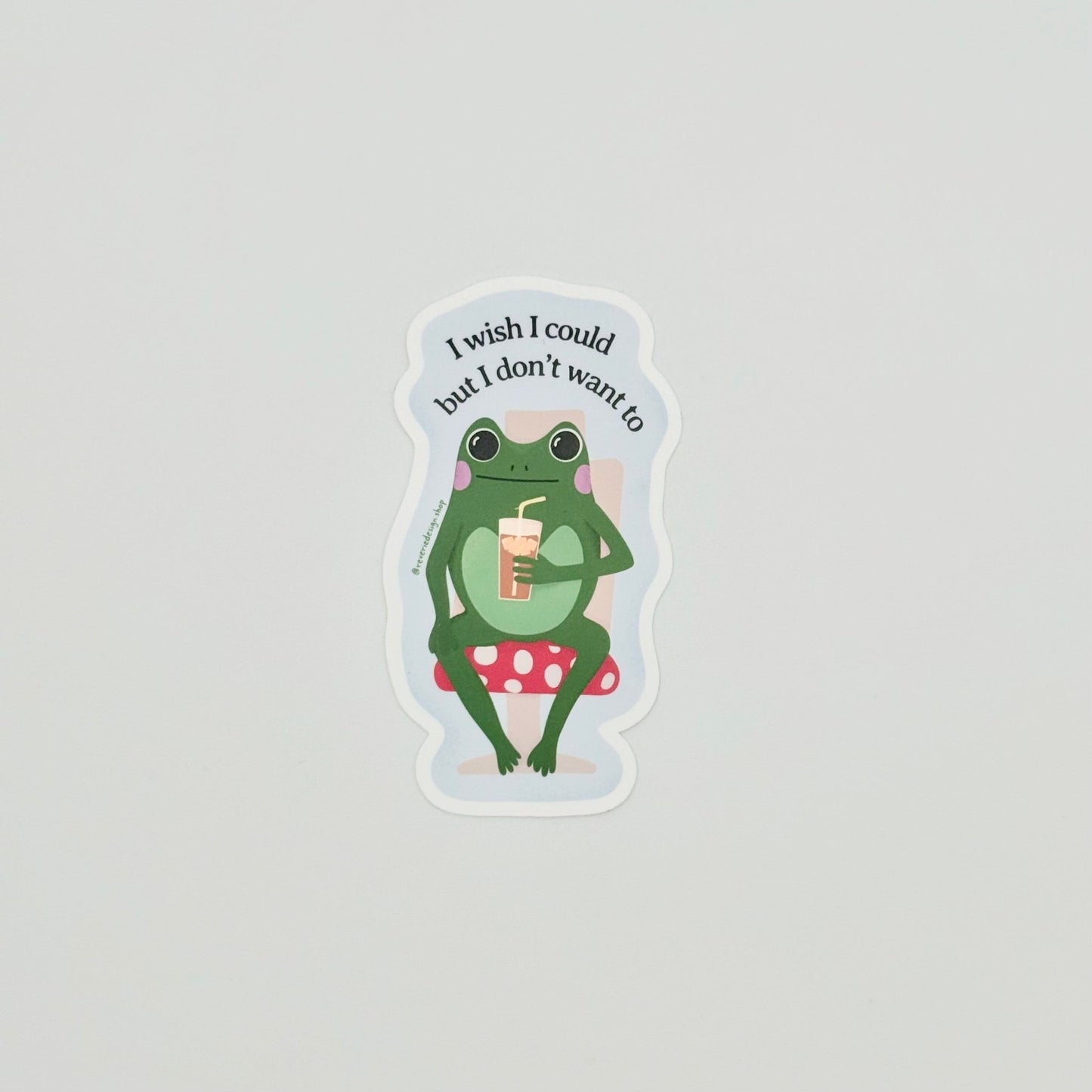 Avoidance humor sticker with cute frog on mushroom chair and text ‘I wish I could, but I don’t want to’
