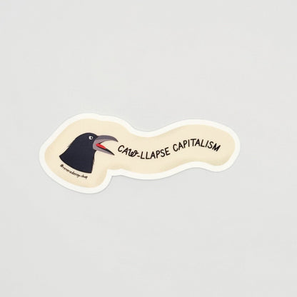 Angry crow sticker with text ‘Caw-llapse Capitalism’ in bold