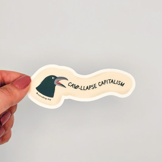 Matte vinyl anti-capitalist sticker featuring yelling background and  crow illustration r with text ‘Caw-llapse Capitalism’ in bold