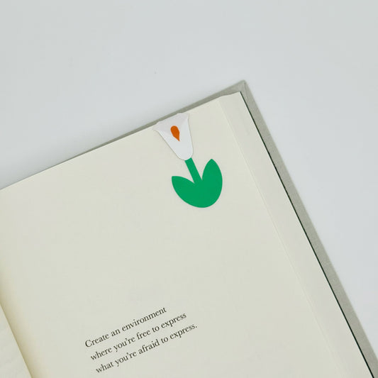 White peace lily magnetic bookmark clipped to book page