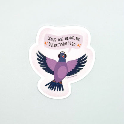Neurodivergent pigeon sticker for sensory overstimulation with funny text ‘Leave me alone I’m overstimulated’