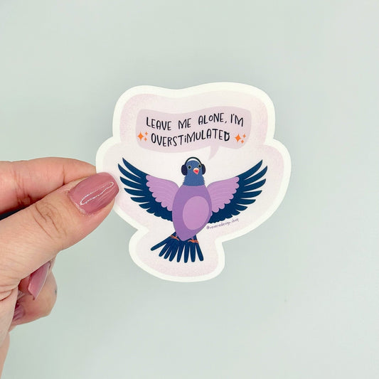 Funny vinyl sticker with wide-eyed pigeon and text ‘Leave me alone I’m overstimulated