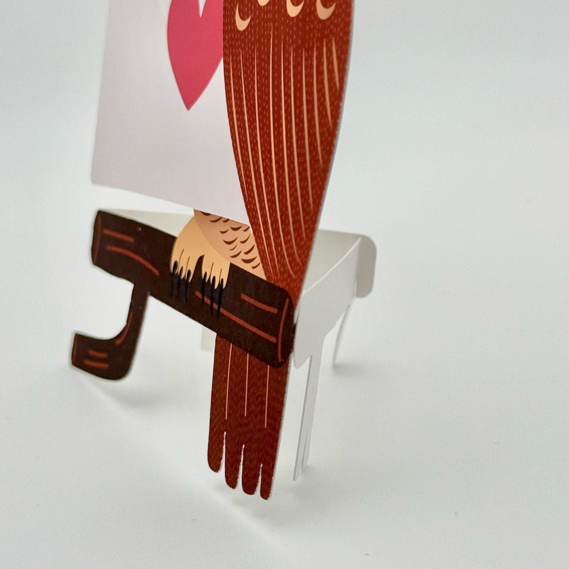 close up of inbuilt stand for die-cut owl greeting card - with pun messages and holding removable cards for personal note