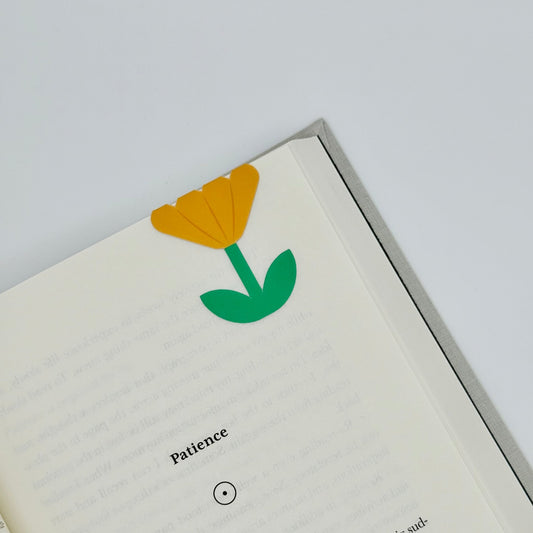 Yellow buttercup magnetic bookmark folded over book page, cute yellow flower with matte finish and strong magnet